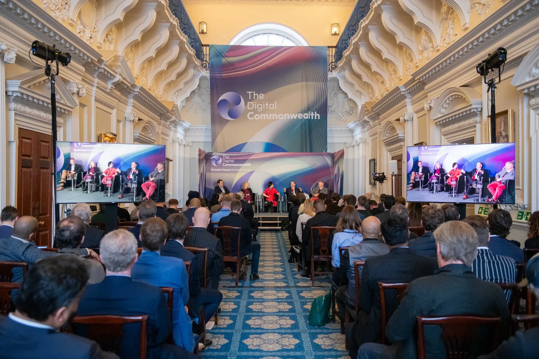 Summit audience and panel on stage at Mansion House